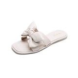 Flache Slide-Sandalen mit Schleife