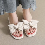 Flache Slide-Sandalen mit Schleife