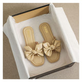 Flache Slide-Sandalen mit Schleife